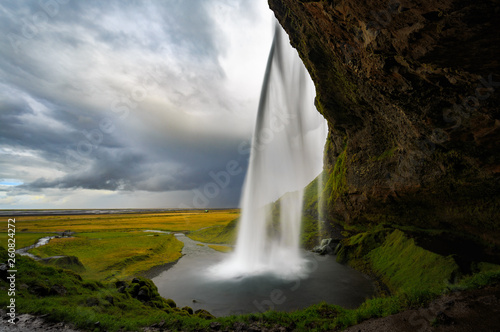 View from behind the Seljalandsfoss waterfall in Iceland.
