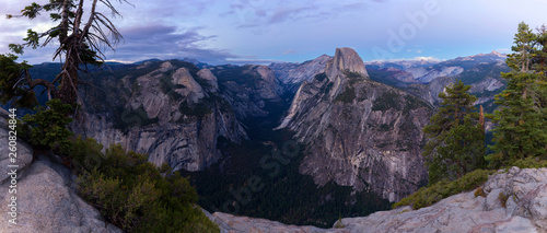 A panorama shot from Glacier Point down into the famous valley of Yosemite National Park shortly after the sun has set. On the right is the Half Dome.