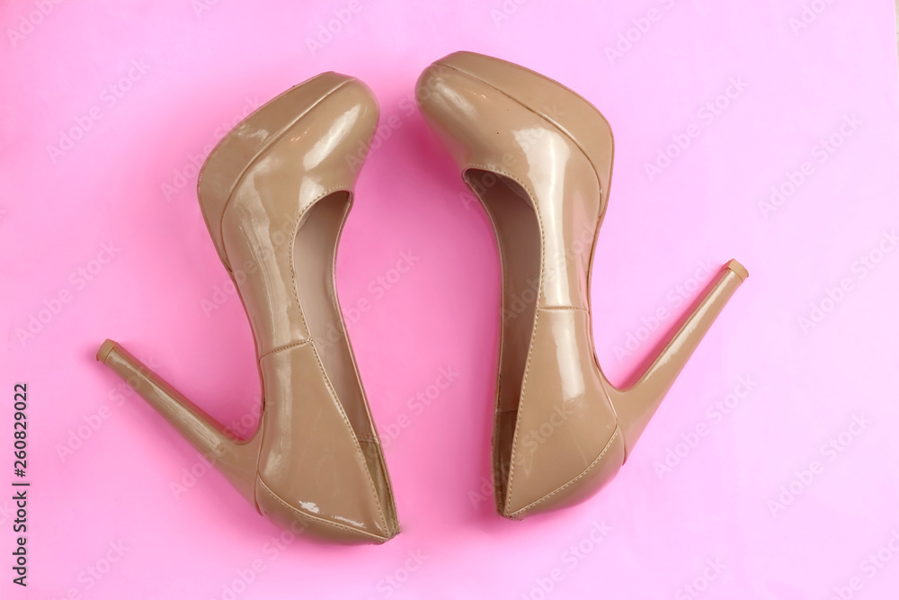 Trendy glamour fancy beige nude pink patent glossy pair of elegant high heeled shoes on pink background Trendy glamour fancy beige nude pink patent glossy pair of elegant high heeled shoes on pink background