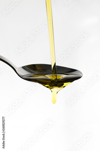 Oil being poured onto a spoon