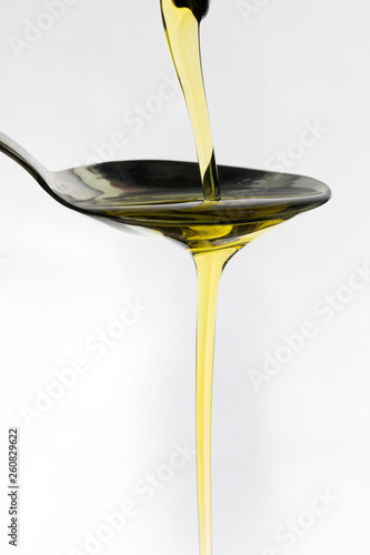 Oil being poured onto a spoon