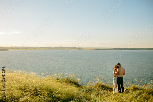 Love, romantic and nature concept - young couple hugging near the lake. Russia