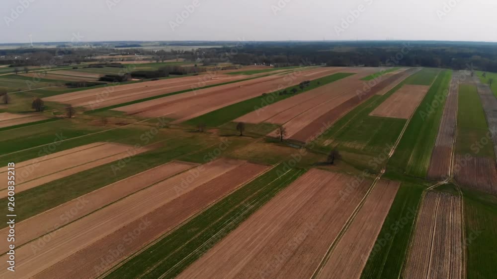 Aerial view of a bunch of fields having been plowed by a tractor. Aerial view of a bunch of fields having been plowed by a tractor.