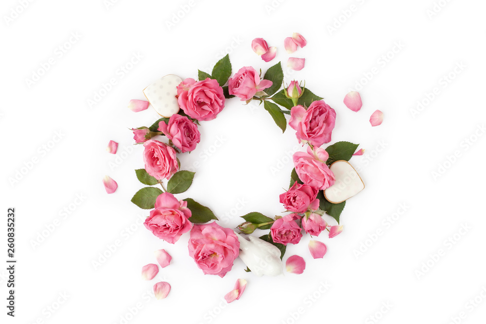 Floral wreath made of roses and leaves. Natural round frame isolated on white. Holiday concept.