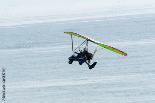 An ultralight trike in flight over the Florida coast. photo