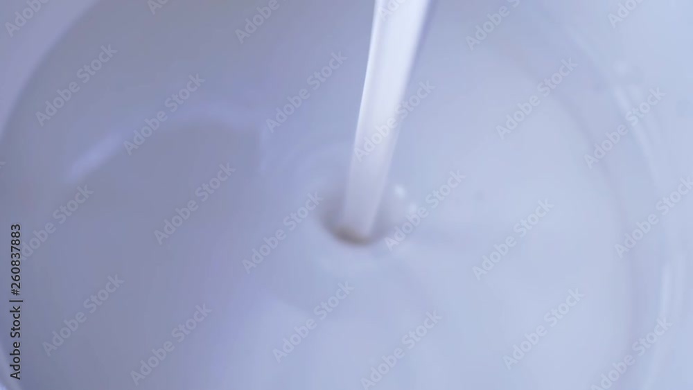 liquid paint is poured into a jar.closeup liquid paint is poured into a jar.closeup