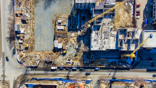 Aerial flat view of cranes on construction site of building in downtown © Sergei Gorin
