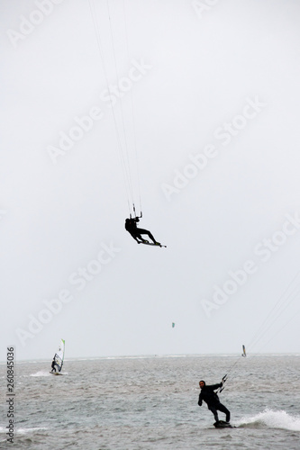 kitesurfer performing a tailgrab over kite photo