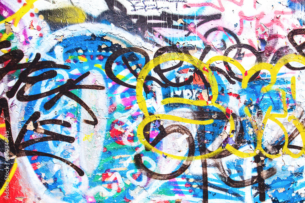 Closeup of texture damaged colorful graffiti wall