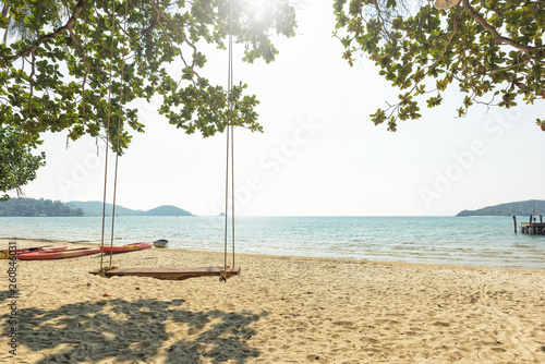 Tropical beach and swing under trees © yotrakbutda