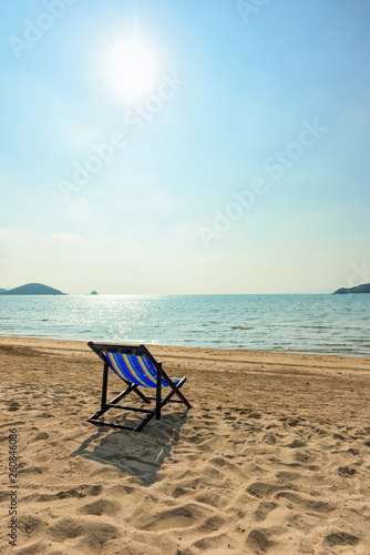 Beach chairs on the white sand beach and tropical sea in Thailand.