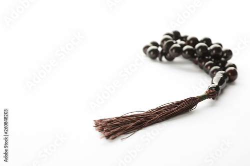 Prayer beads on white background, space for text