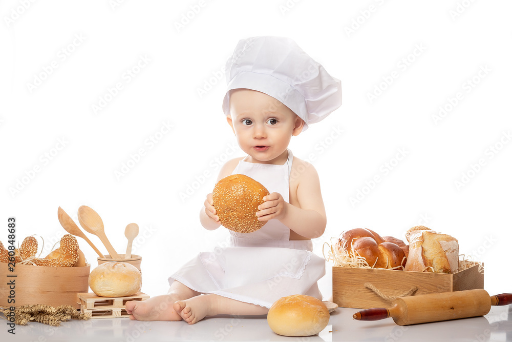 Little Cook Boy With Bread. Isolated on white background. Cooking child lifestyle concept. Toddler playing Little Cook Boy With Bread. Isolated on white background. Cooking child lifestyle concept. Toddler playing