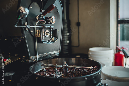 Coffee roasting in small roastery. Coffee roasting machine, Production of coffee.