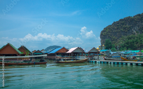 Floating village of sea gypsies near the rocks in the sea. Archipelago in the Andaman Sea. Thailand.