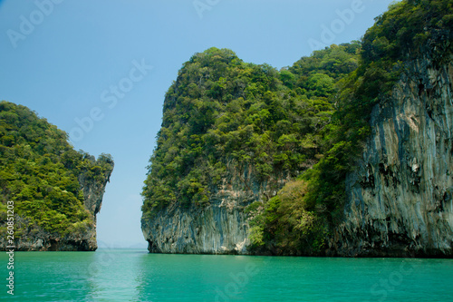 Beautiful view of the islands and ocean. Green sheer cliffs cover tropic plants. Archipelago in Andaman Sea, Thailand. © Nataly