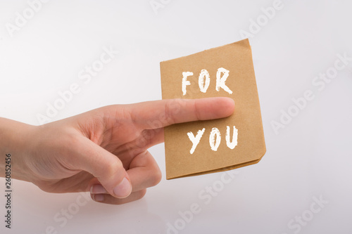  For you text in hand as love cocept on  white background