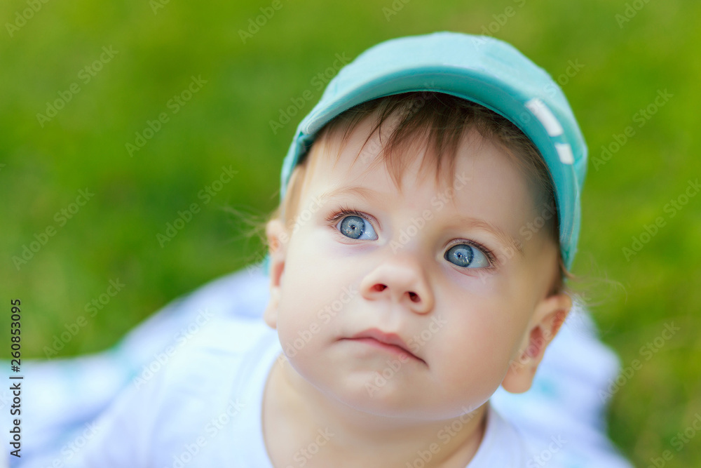 portrait of a young boy blond with blue eyes who smiles in the summer in sunny weather portrait of a young boy blond with blue eyes who smiles in the summer in sunny weather