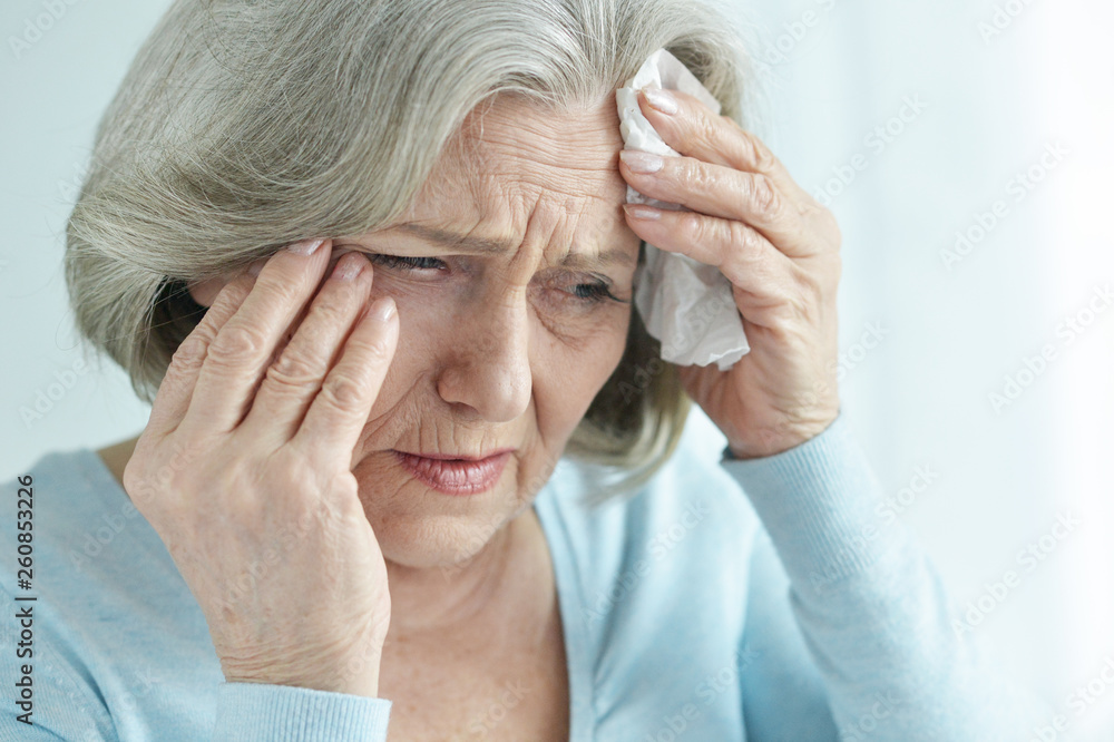 Close up portrait of beautiful sad senior woman with headache Close up portrait of beautiful sad senior woman with headache