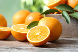 Ripe oranges on table against blurred background