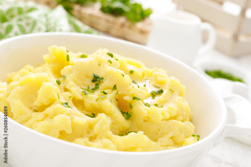 Mashed potato with butter and milk on table Mashed potato with butter and milk on table