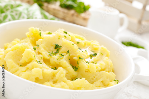 Mashed potato with butter and milk on table