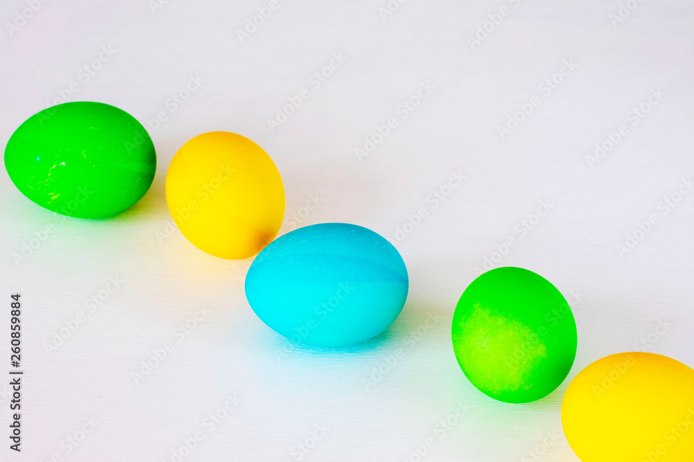 Easter eggs multicolored isolated on white background. Minimal easter concept. Happy easter card with copy space for text. Top view, flat.