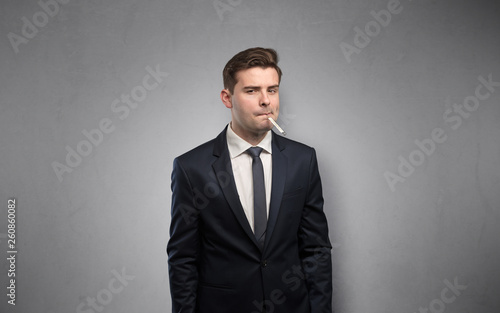 Young tired businessman with thermometer and copy space 