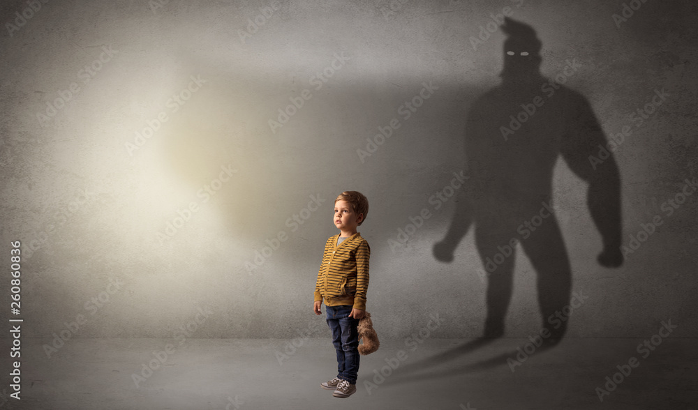Cute kid in a room with plush on his hand and hero shadow on his background
Cute kid in a room with plush on his hand and hero shadow on his background