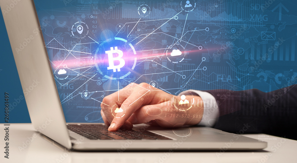 Hand checking on laptop global bitcoin exchange rate concept
Hand checking on laptop global bitcoin exchange rate concept