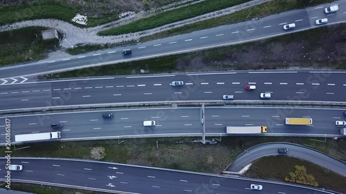 Highway traffic aerial top down view footage from drone with vehicles driving on freeway road with ramp lanes, 4K video of transportation from above