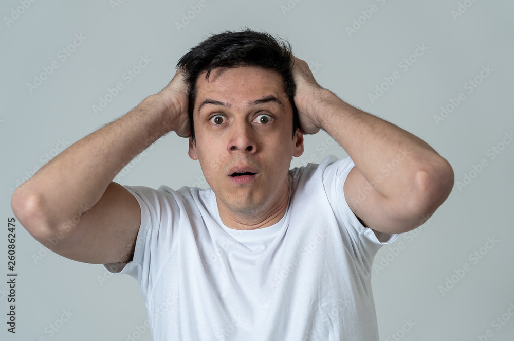 Portrait of a young man looking scared and shocked. Human expressions and emotions Portrait of a young man looking scared and shocked. Human expressions and emotions