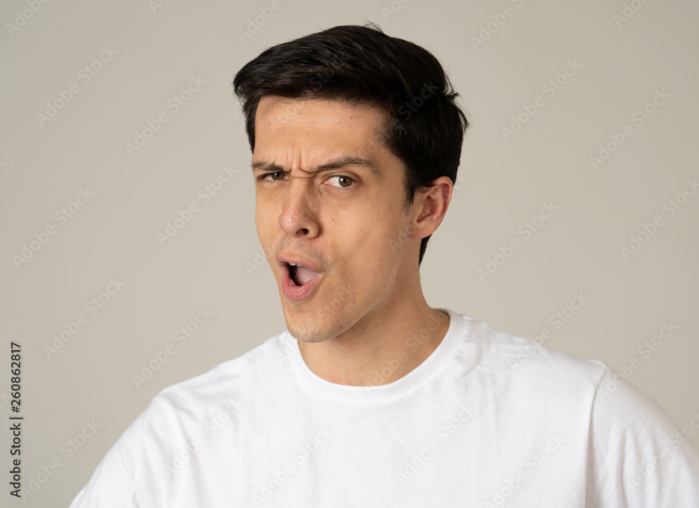 Portrait of young handsome cheerful man with smiling happy face. Human expressions and emotions Portrait of young handsome cheerful man with smiling happy face. Human expressions and emotions