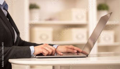 Business woman in homey environment using laptop with global financial report concept  