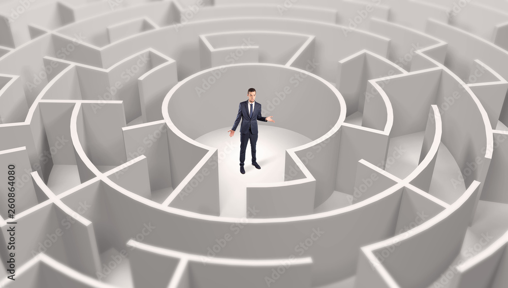 Young businessman standing in a middle of a 3d round maze
Young businessman standing in a middle of a 3d round maze