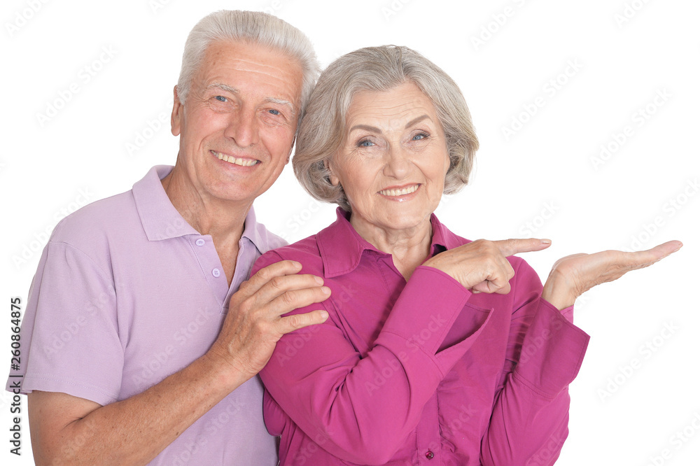 Portrait of a happy senior couple pointing to the right Portrait of a happy senior couple pointing to the right