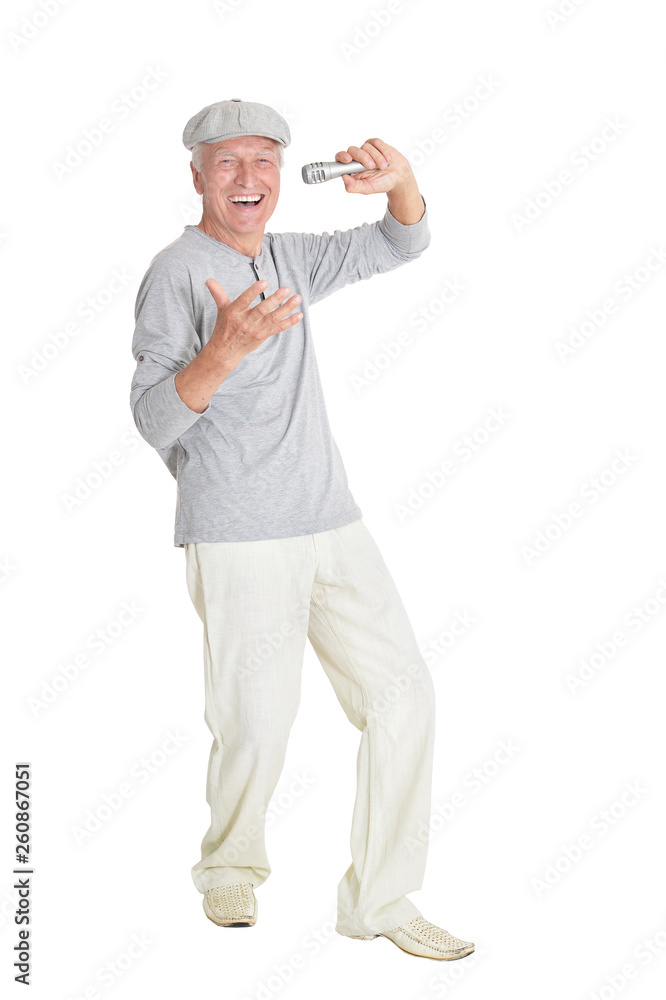 Portrait of senior man singing karaoke on white background