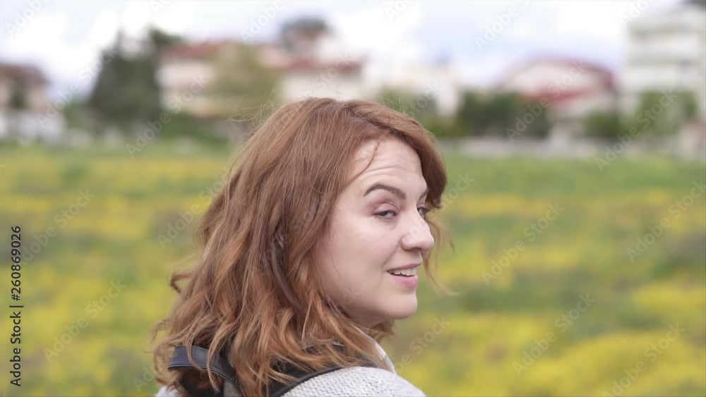 Woman turns and smiles, Enjoying Spring in the field Woman turns and smiles, Enjoying Spring in the field