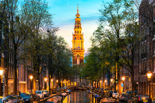 Photography Amsterdam Zuiderkerk church tower at the end of a canal in the city of Amsterdam, Netherlands at night