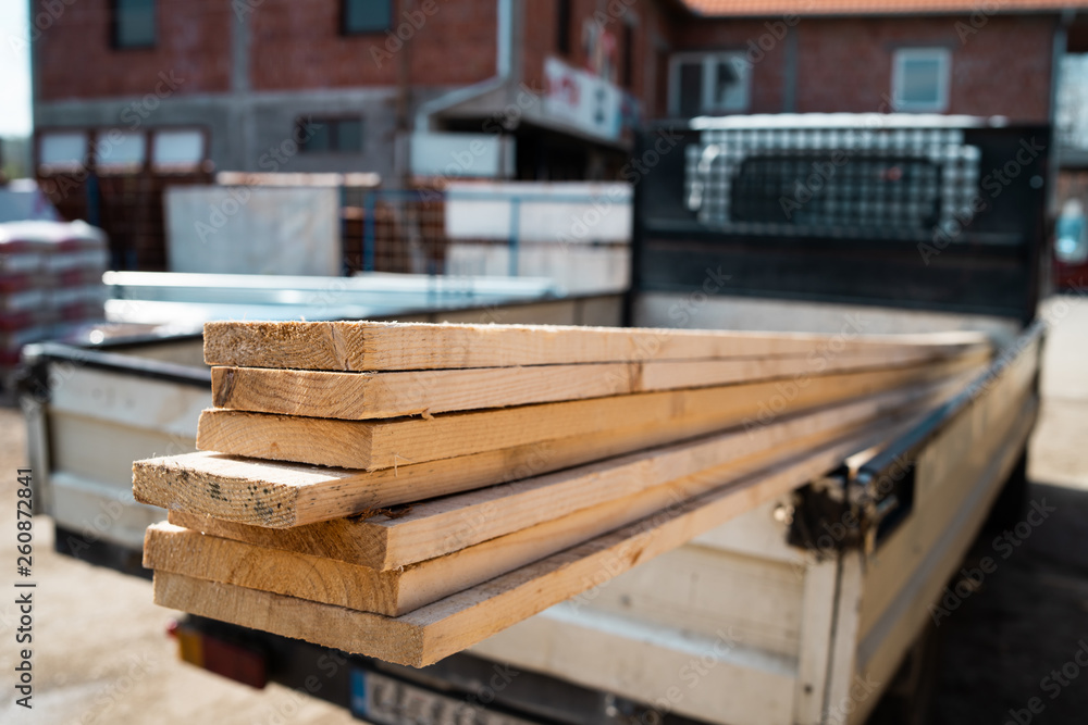 Building material planks in the truck ready to delivery to the construction site Building material planks in the truck ready to delivery to the construction site