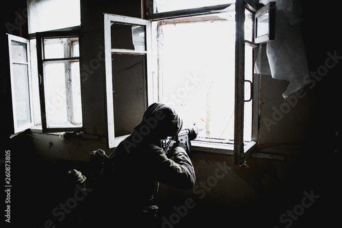 Stalker, a soldier guy in uniform and with a gun shoots from a window in an old, abandoned house
