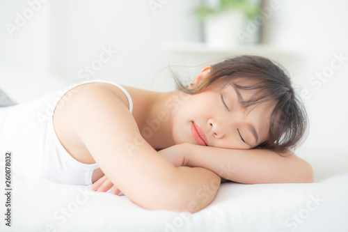 Beautiful asian young woman smile sleeping lying on bed with comfortable and happy leisure at bedroom  beauty asia girl wellness with relax and fresh for health concept.