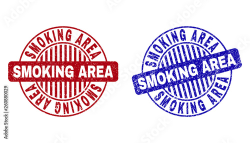Grunge SMOKING AREA round stamp seals isolated on a white background. Round seals with grunge texture in red and blue colors.