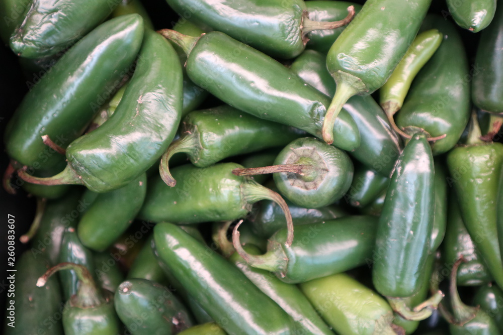 Green jalapeno peppers on market