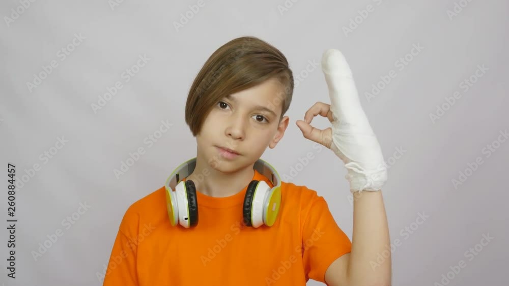 The sequence of different emotions and gestures. OK, a gesture with a sore hand in a cast. gesture indoors The sequence of different emotions and gestures. OK, a gesture with a sore hand in a cast. gesture indoors