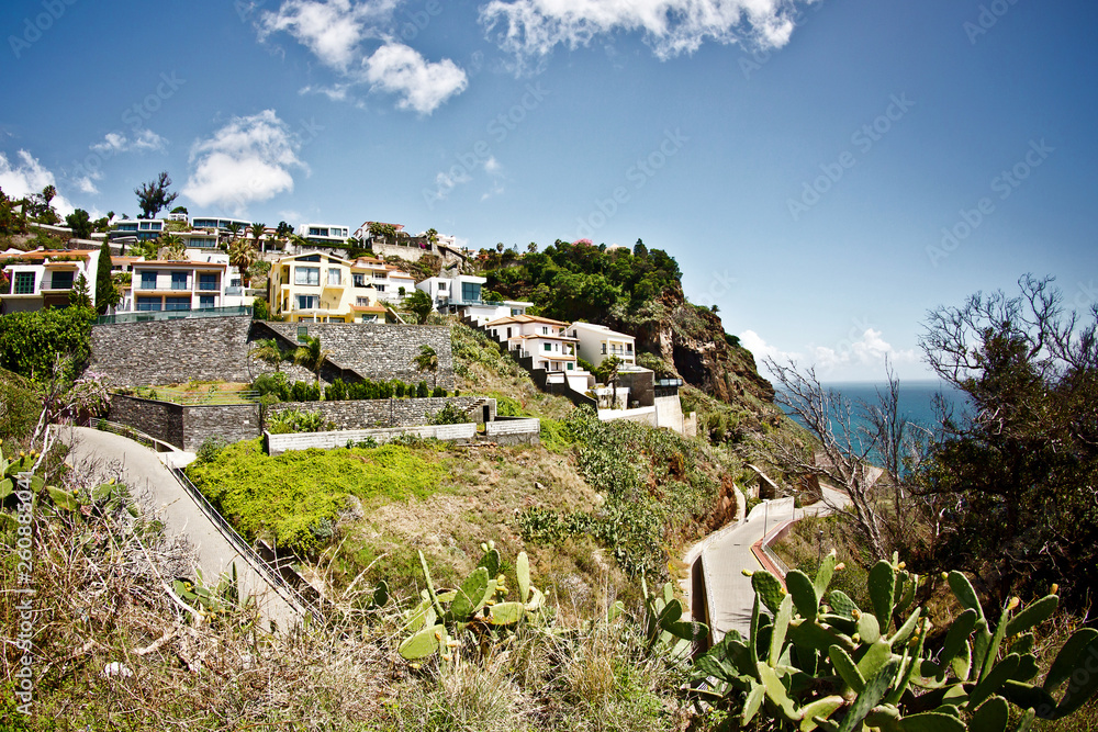 Sunny holiday village on a cliff. Small town by the sea landscape.