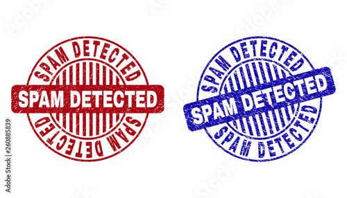 Grunge SPAM DETECTED round stamp seals isolated on a white background. Round seals with grunge texture in red and blue colors.