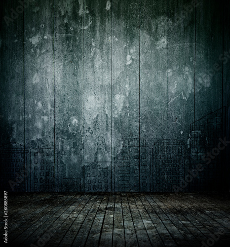 Empty dark room interior with old mottled doodles concrete wall and dirty wooden floor for background texture.