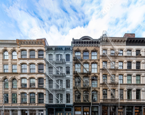 Exterior view of old apartment buildings in the SoHo neighborhood of Manhattan in New York City with empty blue sky