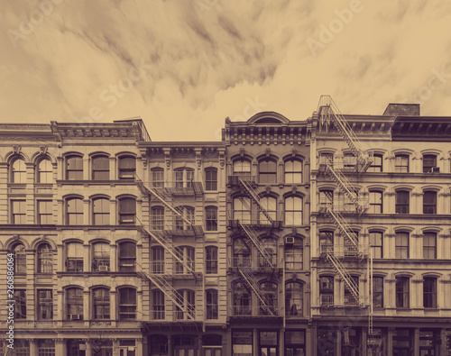 Photography Old historic buildings in the SoHo neighborhood of New York City with faded sepi